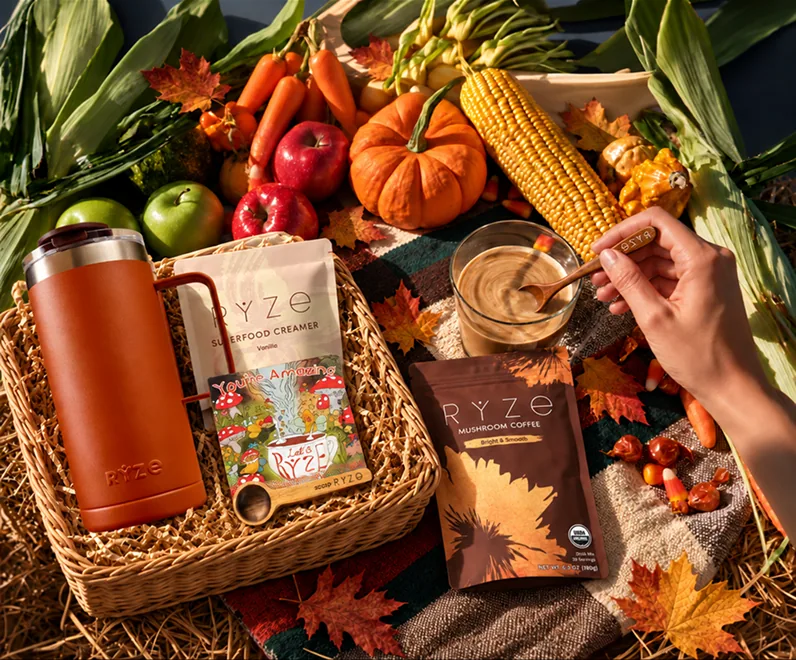 RYZE mushroom coffee, creamer and tumbler in a harvest basket